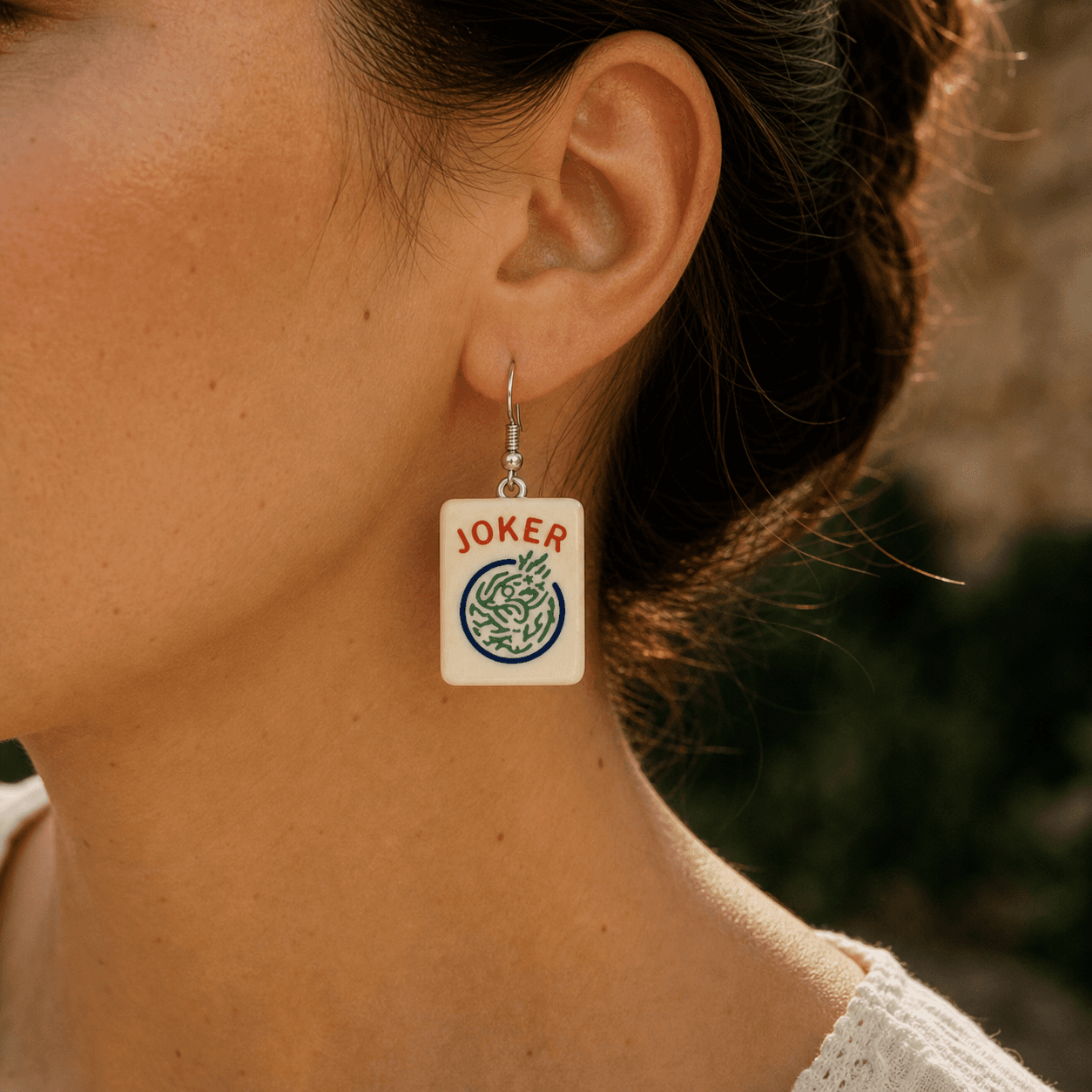 Mahjong Joker Tile Earring worn, showing the roughly 1.5-inch tile in golden evening light