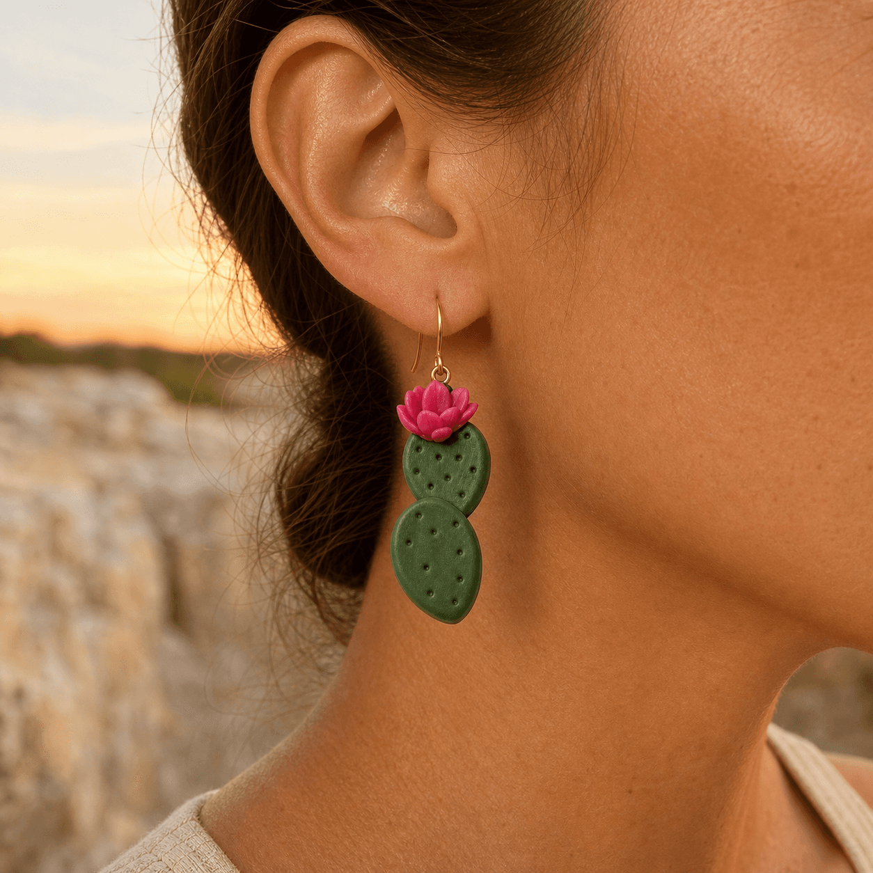 Prickly Pear Cactus Earring worn, showing the roughly 2.25-inch drop against a Hill Country sunset